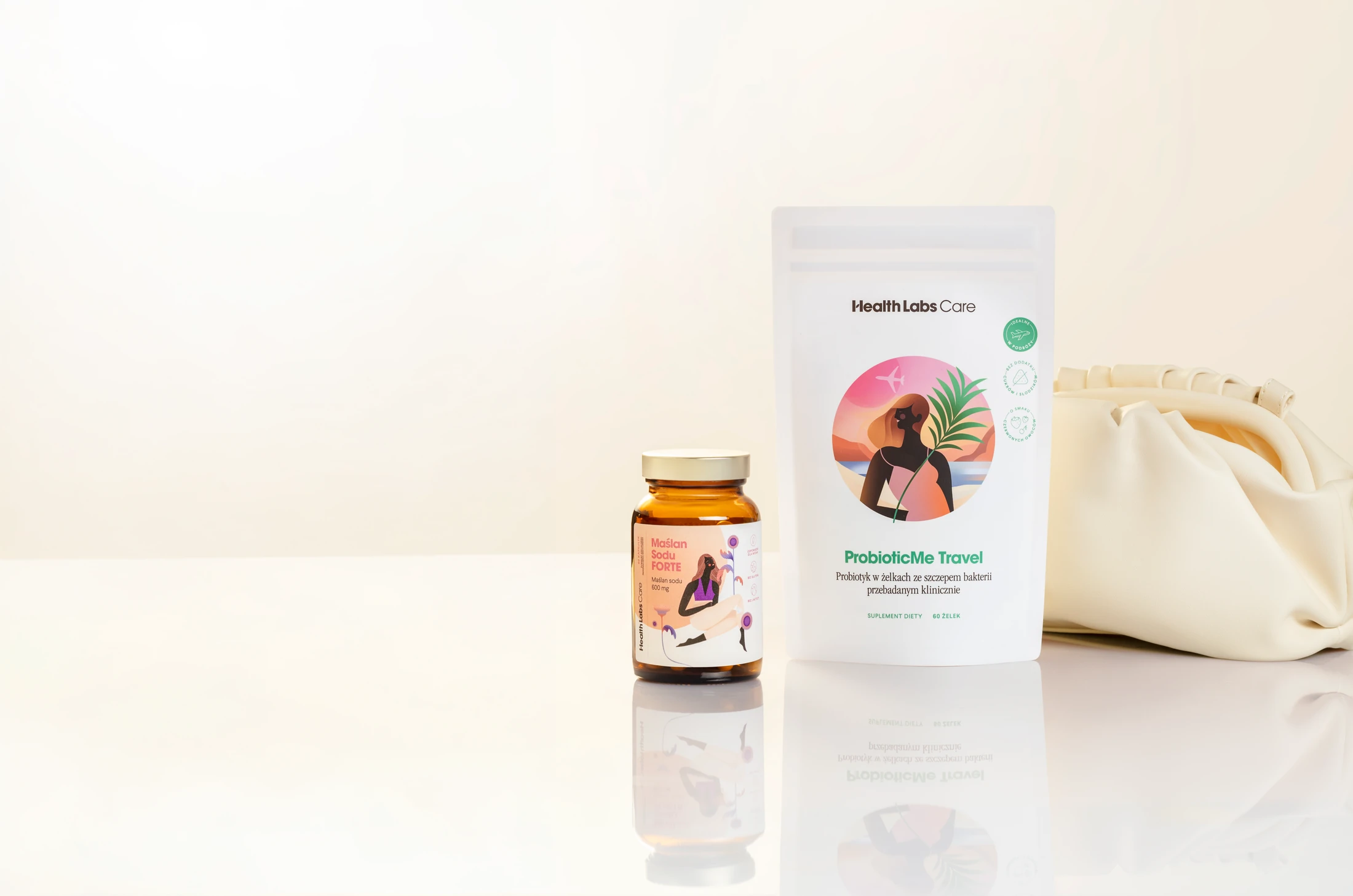 ProbioticMe Travel and Maślan Sodu Forte beside a cream travel bag